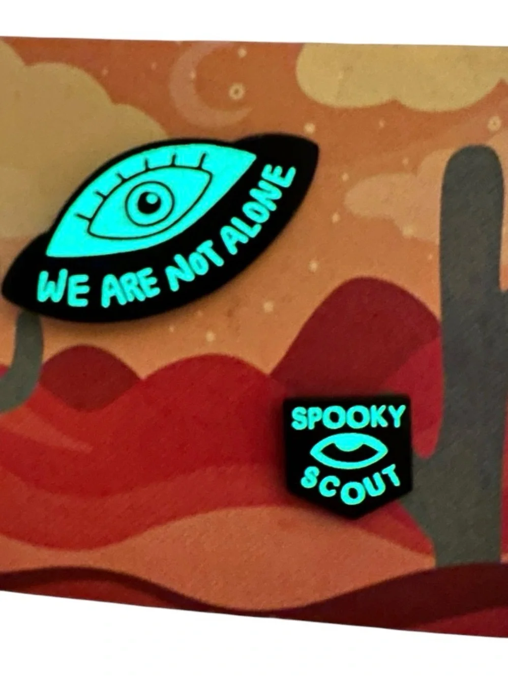 New Spooky Scouts Podcast Glow in the dark UFO Eye and Badge pin set
